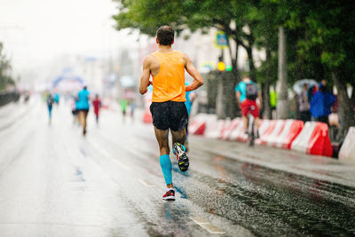 Rear view of man running on street