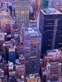 High angle view of illuminated street amidst buildings in city