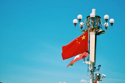 Low angle view of street light against clear blue sky