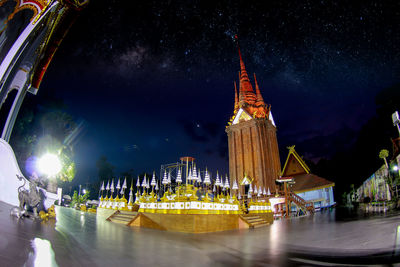 Panoramic view of illuminated building against sky at night