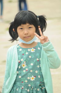 Portrait of girl wearing mask gesturing