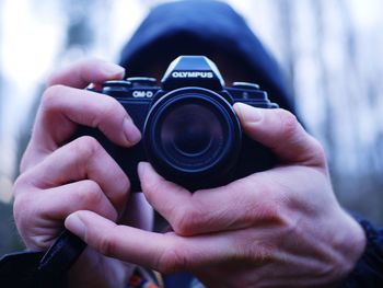 Midsection of man photographing camera