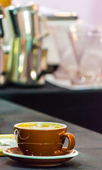 Close-up of coffee cup on table in cafe