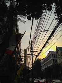 Cars on city against sky during sunset