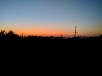 Silhouette trees against sky during sunset