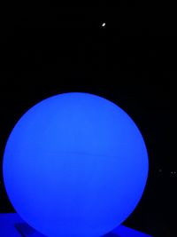 Low angle view of illuminated lamp against sky at night