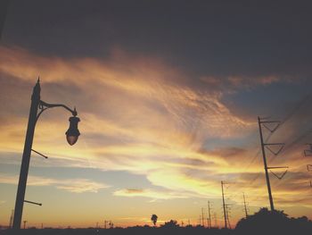 Low angle view of street light against cloudy sky