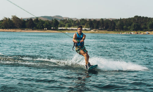 Full length of man doing wakeboard in a lake