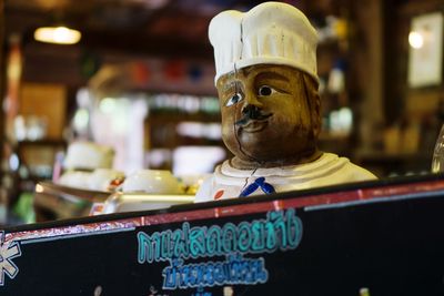 Close-up of buddha statue on table