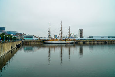 Harbor by sea against sky in city