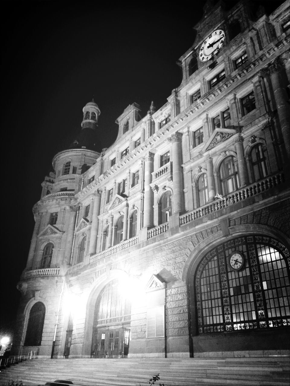 architecture, building exterior, built structure, night, illuminated, low angle view, street, arch, city, street light, building, transportation, car, clear sky, facade, land vehicle, history, incidental people, road, lighting equipment