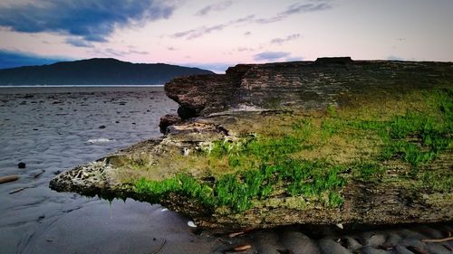 Scenic view of mountain against cloudy sky
