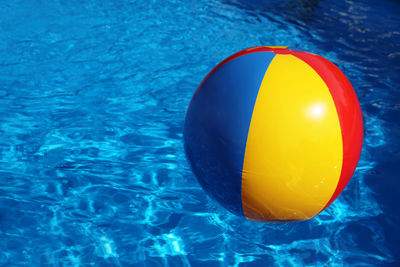 Colorful ball on swimming pool