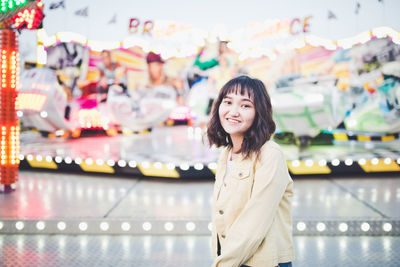 Beautiful asian girl in an amusement park, smiling