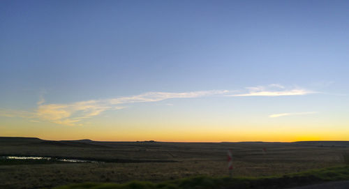 Scenic view of landscape against sky at dusk