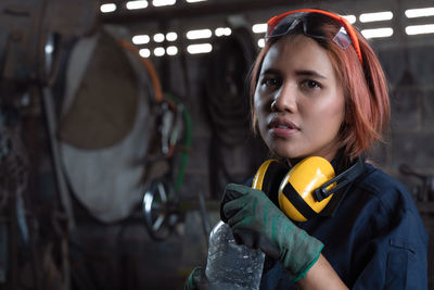 Portrait of female mechanic at garage