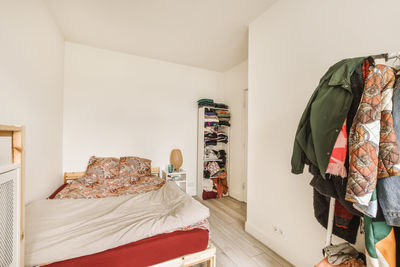 Low section of woman standing on bed at home