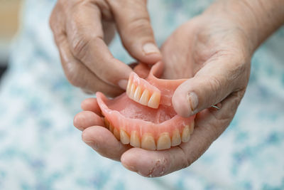 Cropped hand of woman holding pills