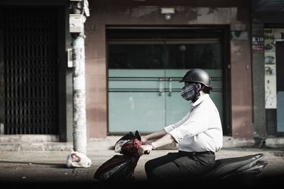 Rear view of man riding motorcycle
