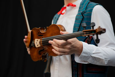 Midsection of man playing violin