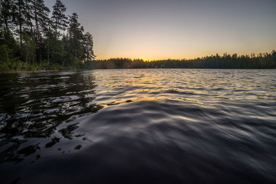 Scenic view of lake against sky at sunset