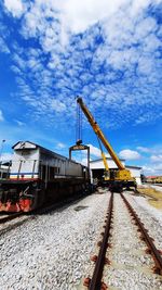 Train at railroad station platform against sky