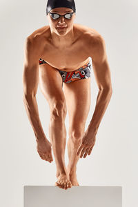 Full length of swimmer against white background