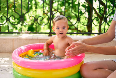 High angle view of shirtless boy in swimming pool