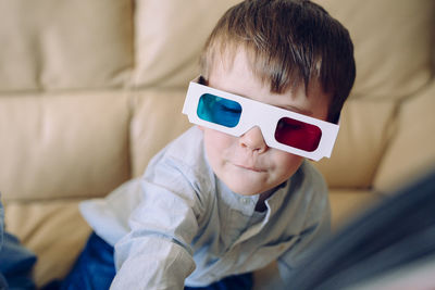 Portrait of boy wearing 3d glasses at home