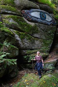 Full length of man standing in forest