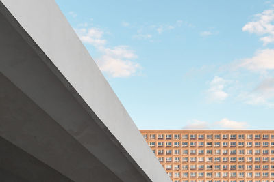 Low angle view of bridge and building against sky