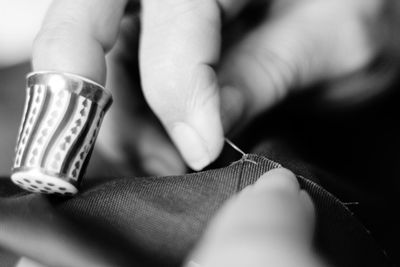 Cropped image of woman sewing on table at home