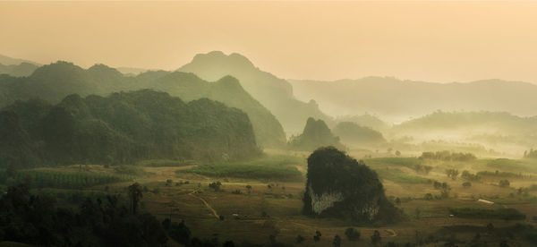 Scenic view of landscape against sky during foggy weather