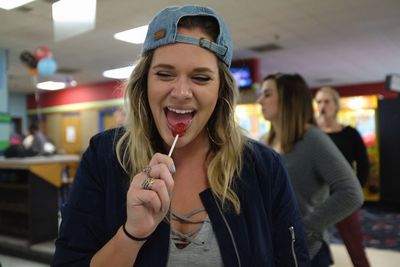 Close-up of smiling young woman eating