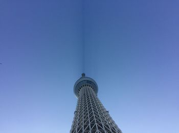 Low angle view of tower against blue sky