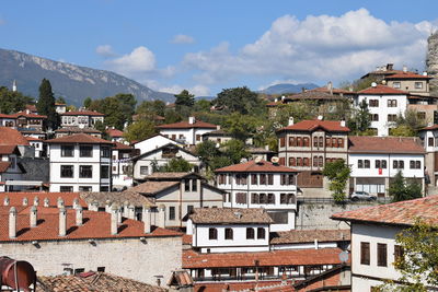 Houses in town against sky