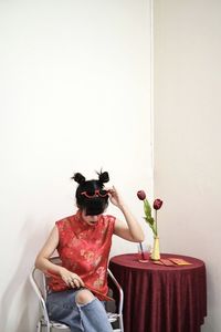 Portrait of woman in red cheongsam top and jeans