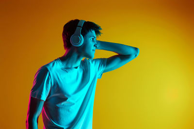 Silhouette man standing against yellow background