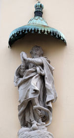 Low angle view of statue against building