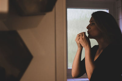 Portrait of woman looking away at home