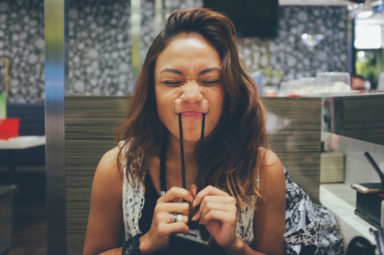 person, young adult, portrait, looking at camera, lifestyles, young women, front view, focus on foreground, indoors, leisure activity, smiling, long hair, headshot, casual clothing, waist up, happiness, brown hair