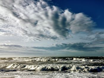 Scenic view of sea against cloudy sky