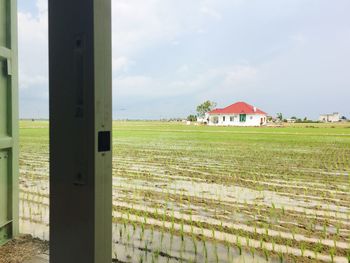 Barn on field against sky