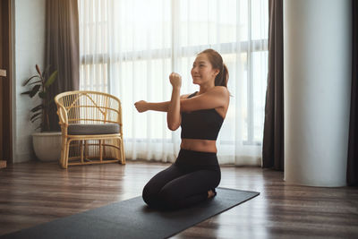 Young woman exercising in gym