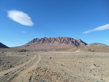 Scenic view of arid landscape against sky