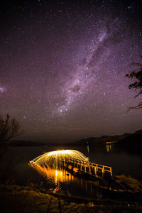 Countryside landscape against starry sky