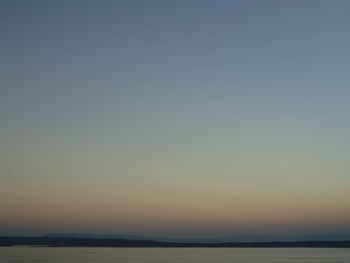 Scenic view of sea against clear sky during sunset