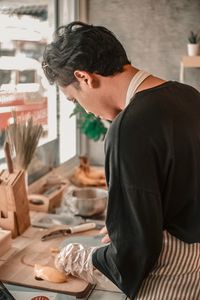 Side view of man working at table