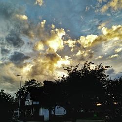 Low angle view of building against cloudy sky