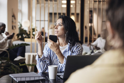 Young woman using laptop at table